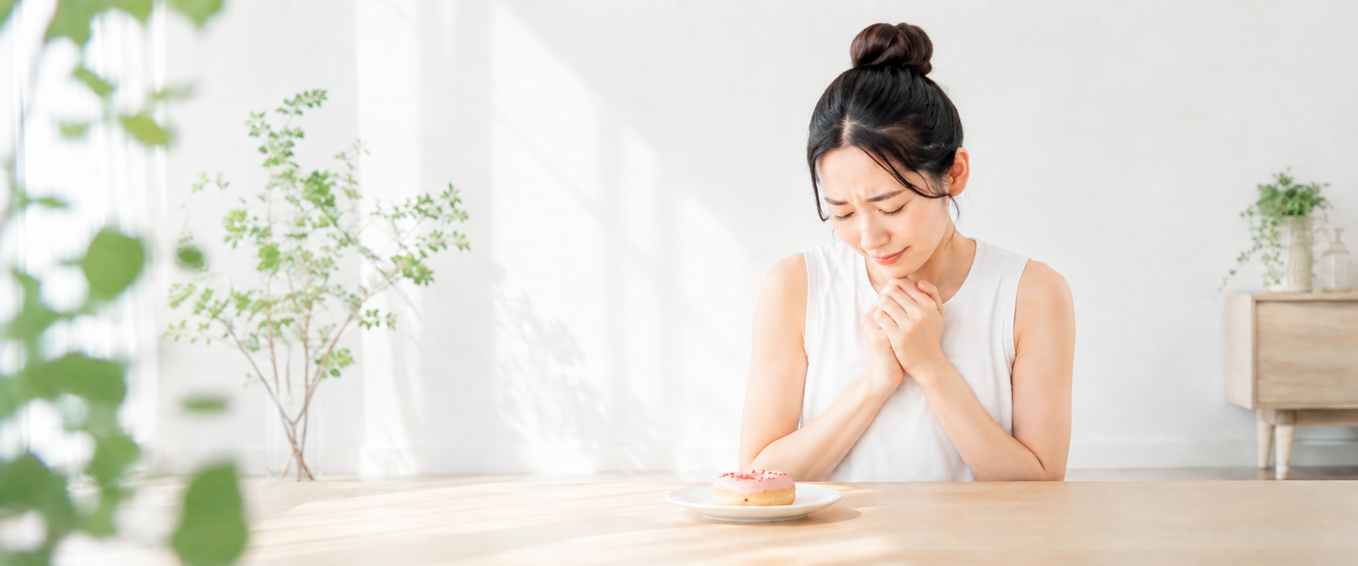 ドーナツの前で申し訳なさそうにする女性